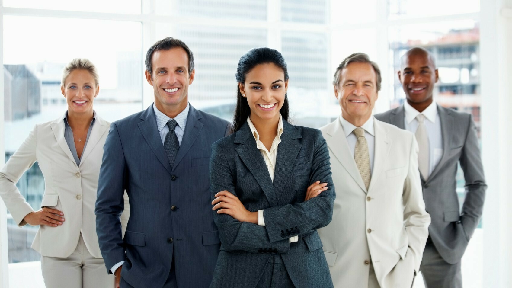 Happy confident business woman heading a team of successful colleagues