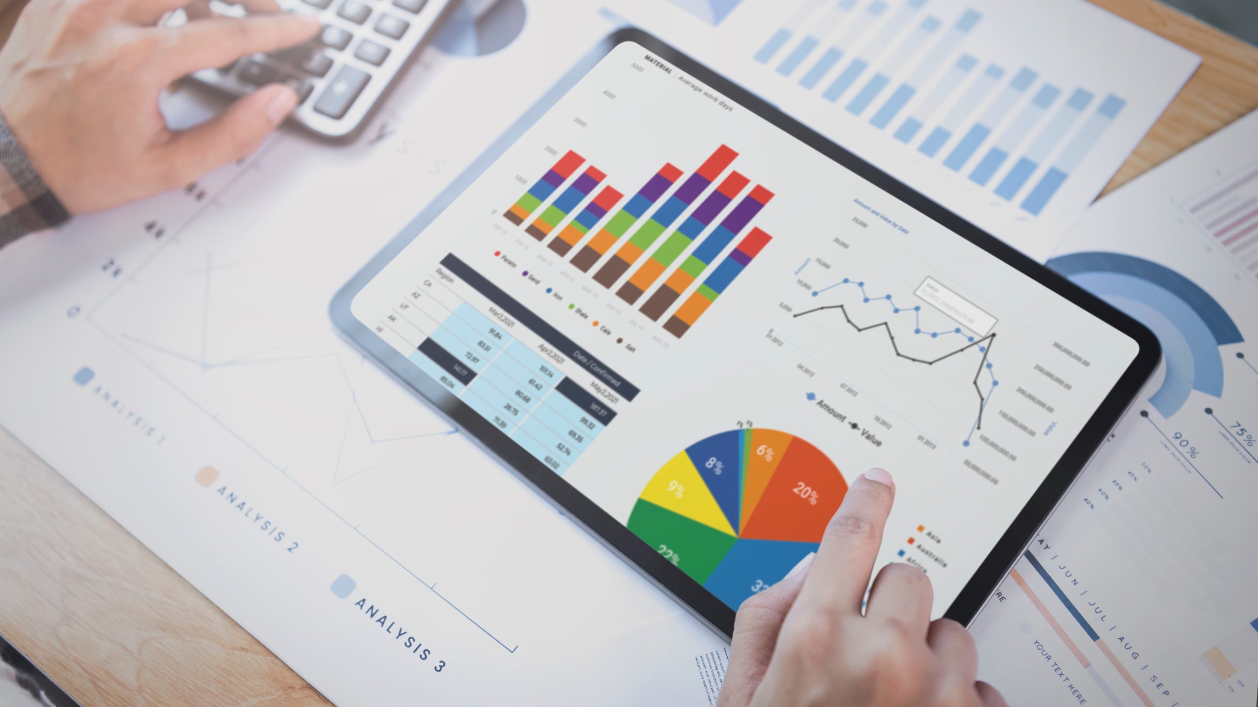 Businesswoman using a tablet to analysis graph company finance strategy statistics success concept and planning for future in office room.